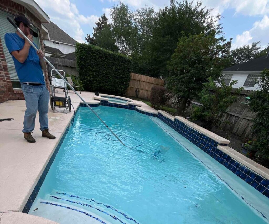 A man cleaning a pool. Pool service near me