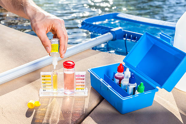 Pool maintenance expert adding phosphate remover to pool