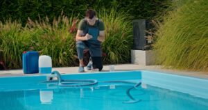 Pool technician restoring green pool water to clear condition in Sugar Land